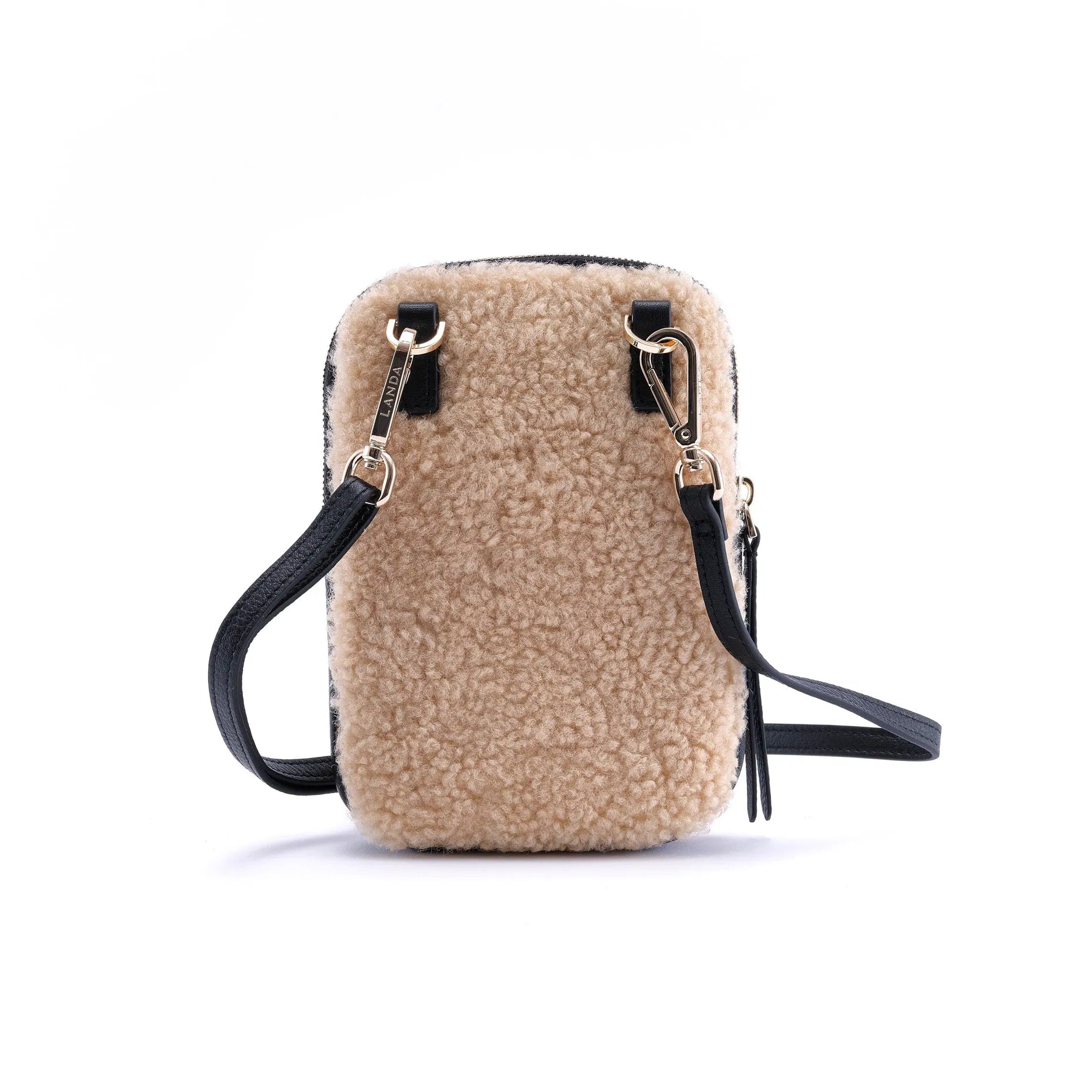 Beige real shearling phone bag with black leather straps on a white background