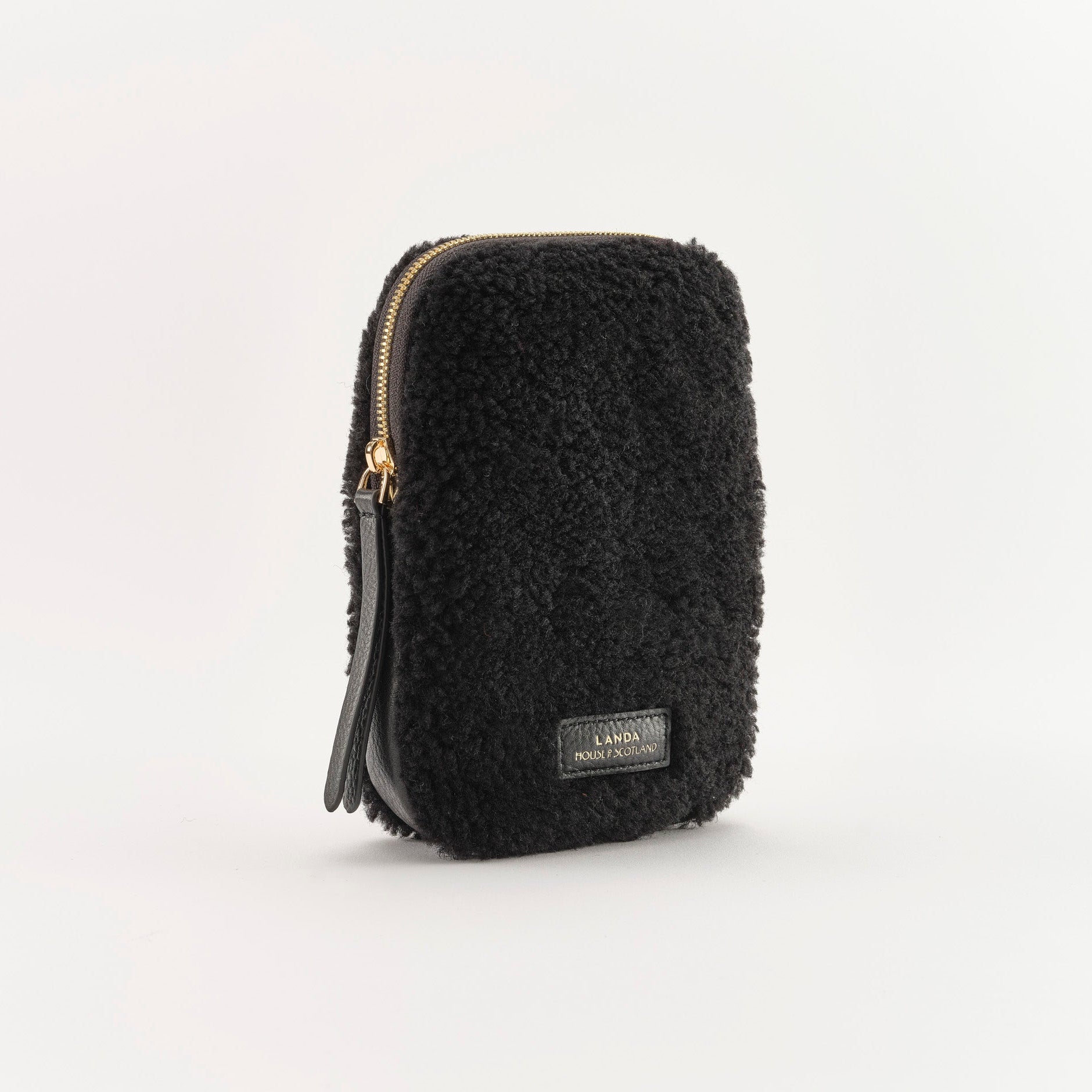 Black textured pouch with a zipper on a white background